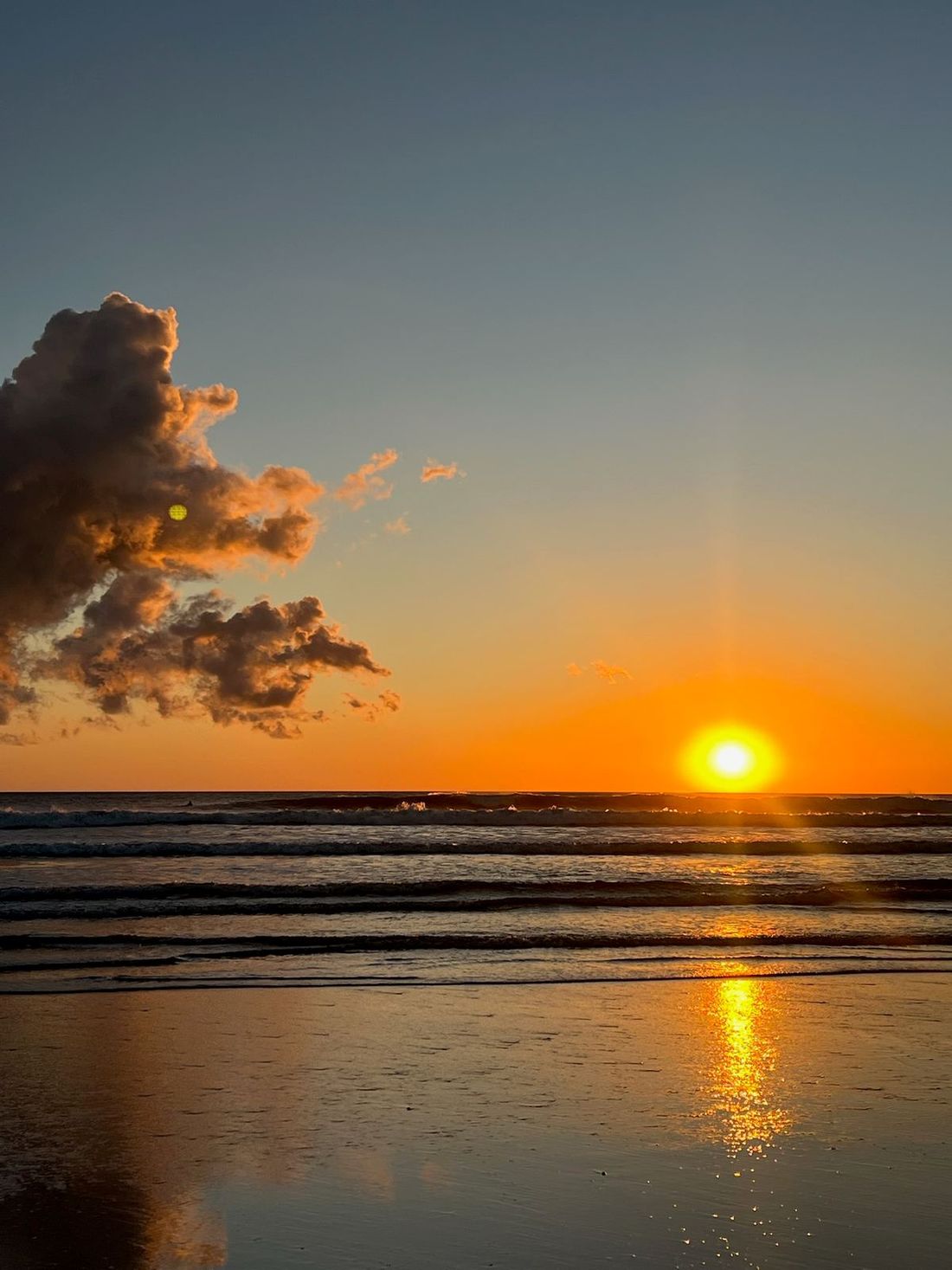 Deep orange cloud bank over the Pacific at sunset